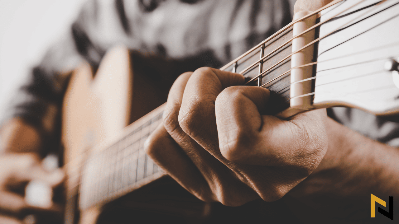 Person playing an acoustic guitar