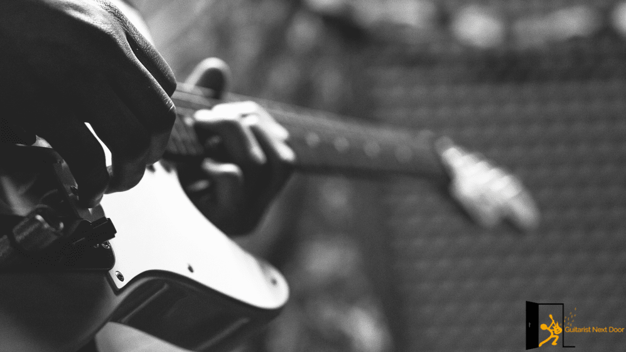 Displays an intermediate guitar player playing a telecaster