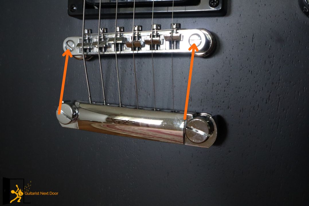 image reveals how to adjust tune-o-matic guitar with screwdriver