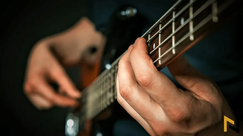 image showing man playing bass guitar