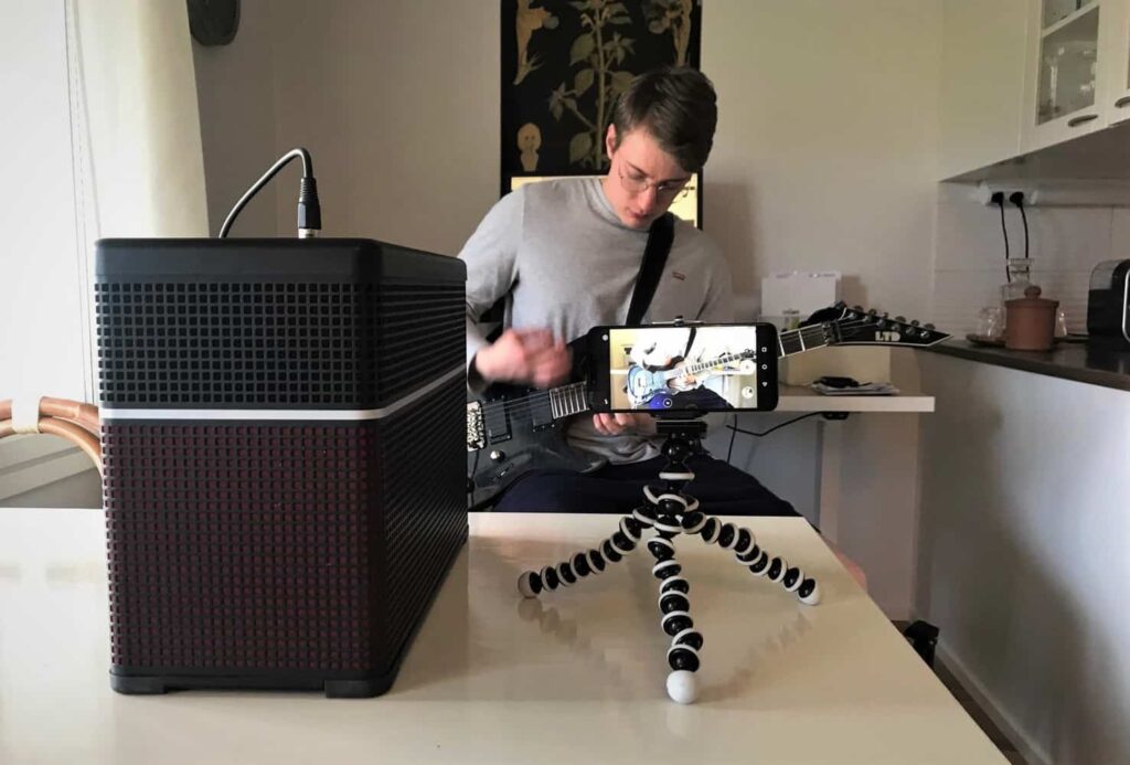 Photo shows readers how to setup their amp and phone when recording guitar playing