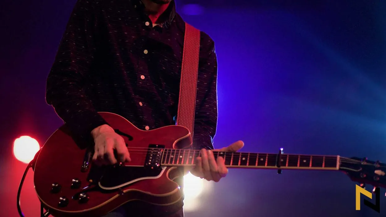 Photo shows readers and hollow body guitar player