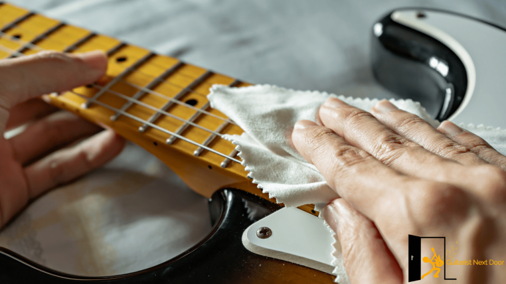 Displays a guitarist cleaning his guitar