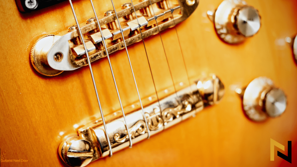 displays a guitar with gold hardware