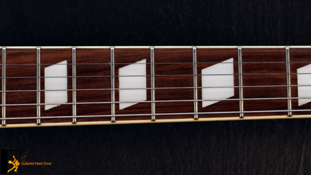 displays a guitar fretboard with jumbo frets