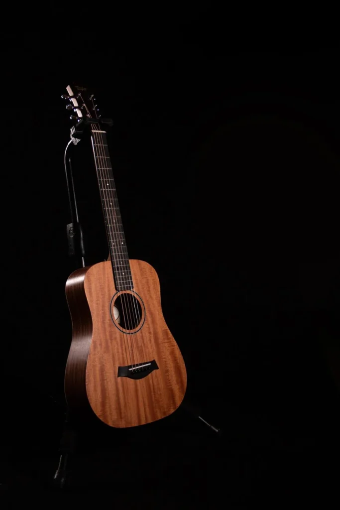 Displays a Beautiful Taylor acoustic guitar costing under 1000 dollars