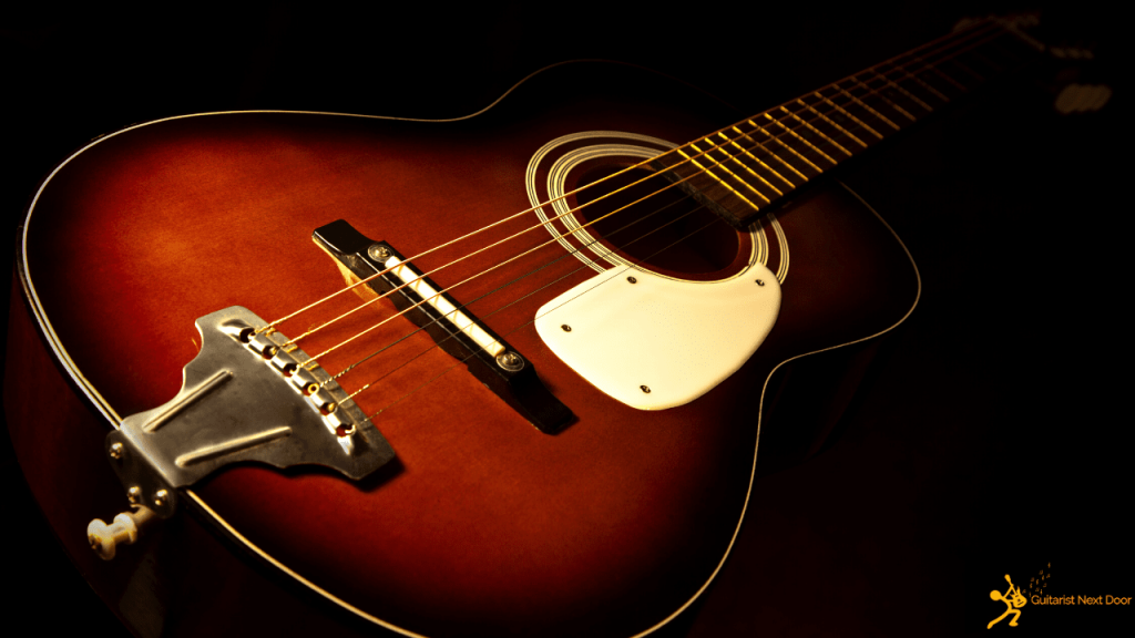 Displays a parlor acoustic guitar