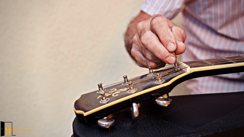 guitar player setting up his acoustic guitar