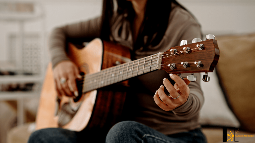 Displays a guitar player tuning her guitar