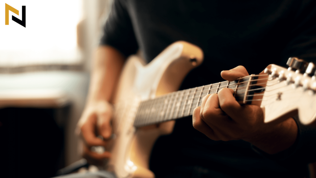 Person with small hands playing the guitar