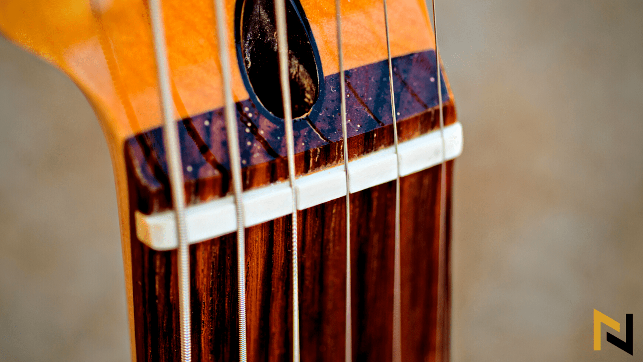 Displays a nut of the guitar