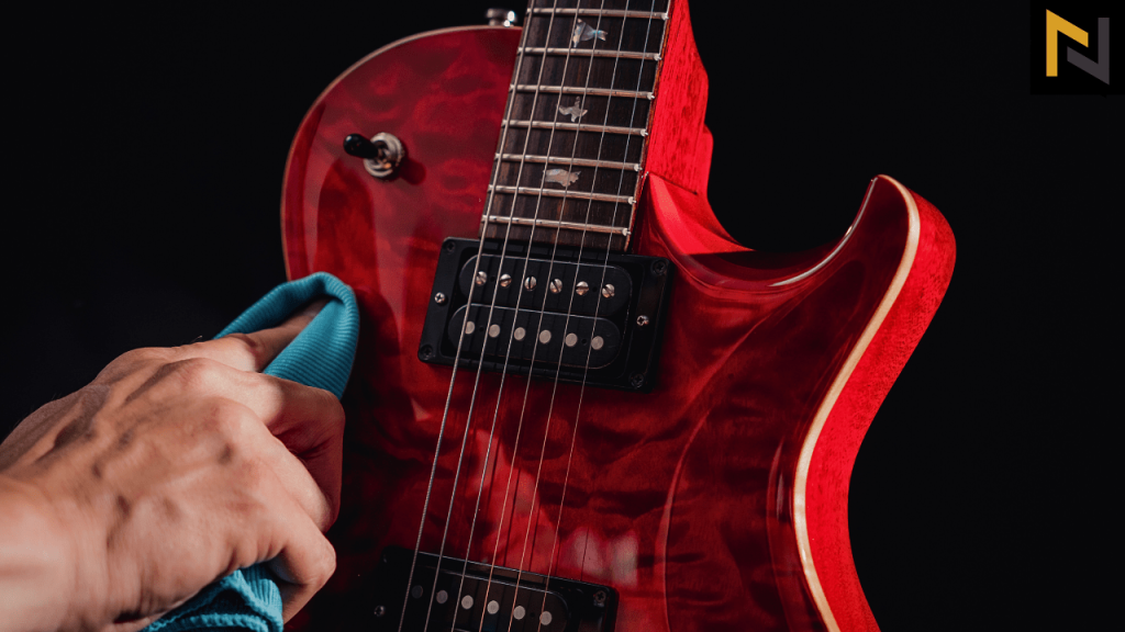 displays a guitar player cleaning guitars body