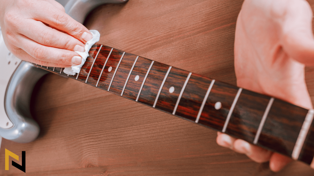 displays a guitar player Polishing the guitar