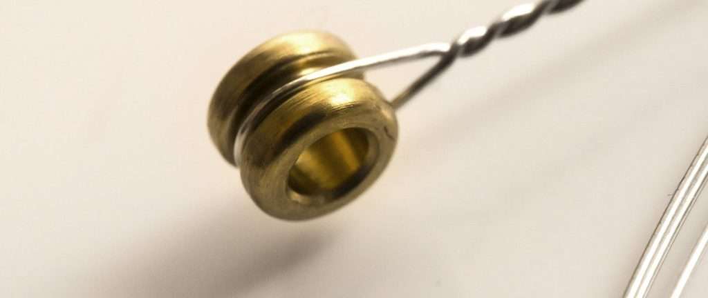 close up of ball end of a guitar string