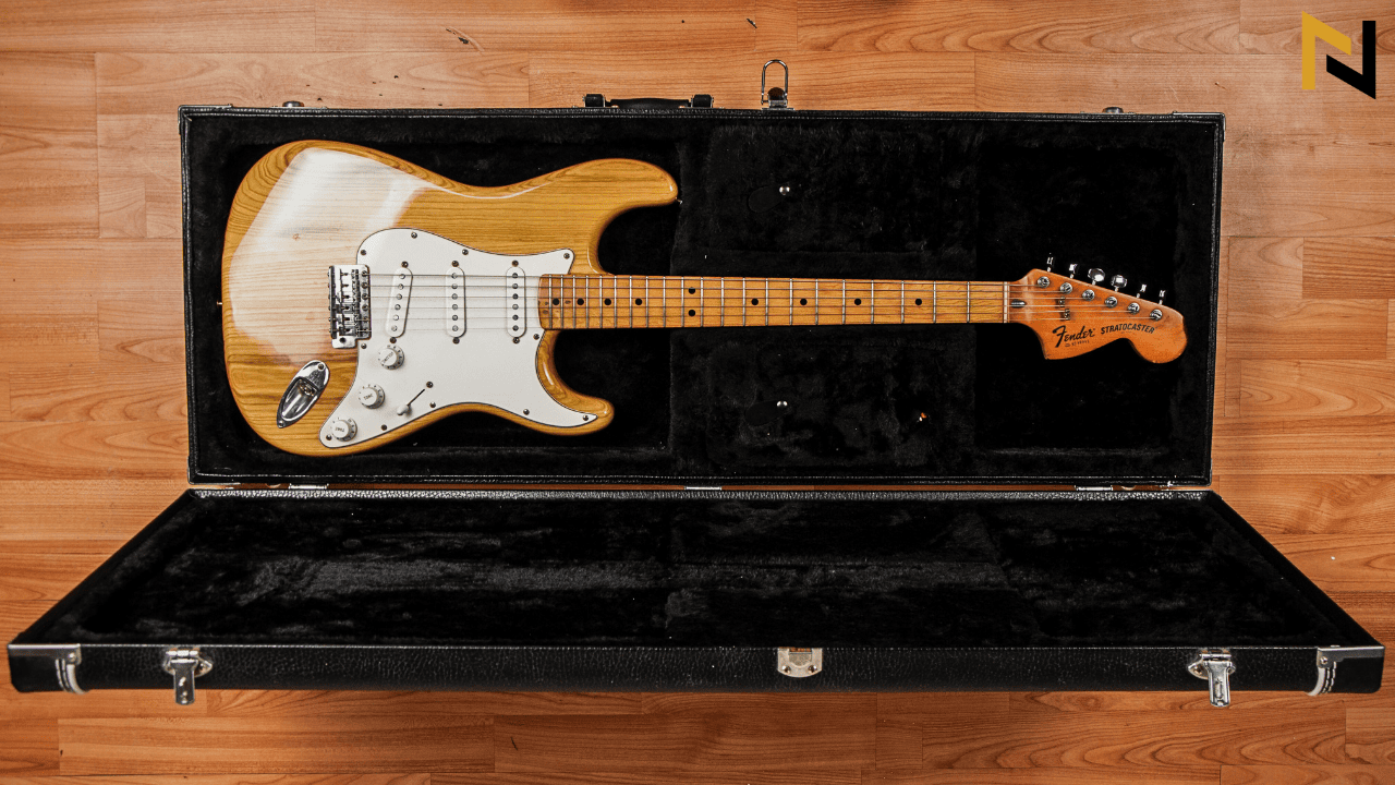 Displays an expensive Fender guitar